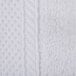 A close up of a white knitted fabric wash cloth with a white border.
