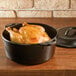 A Lodge cast iron Dutch oven with a chicken inside.