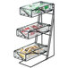 A black metal three tiered display rack with glass trays of condiments.