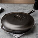 A Lodge cast iron skillet with a lid on top.