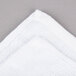 A close up of a white Chef Revival bar towel with a folded edge.