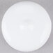 A white round object with a few small circles on a gray surface.