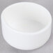 A white round tube cap for Nemco Easy Cheese Blockers on a gray surface.