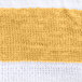 A close up of a white and yellow striped Oxford pool towel.