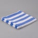 An Oxford blue and white striped pool towel.
