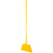 A yellow broom with yellow flagged bristles and a fiberglass handle.