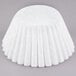 A white round coffee filter with a ruffled edge wrapped in white paper.