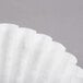 A close-up of a white paper coffee filter.
