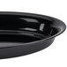 A close up of a Fineline Plastic black deep oval bowl.