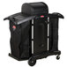 A black Rubbermaid housekeeping cart with wheels and a black cover.