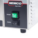 A green square Nemco rocker switch on a power box.