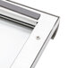 A close up of a stainless steel door with a metal frame for Nemco large heated display cases.
