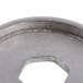 A close-up of a Nemco Replacement Blade Spacer for a CanPRO Compact Can Opener, a circular metal object with a hole in it.