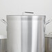 A large silver pot with a Vollrath aluminum pot cover.