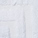 A close-up of a white bathmat with a dobby border and dobby hem.