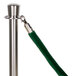 A silver pole with a green fabric rope.