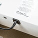 The white Curtron Pest-Pro box with a black cord plugged in.