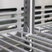 A close up of a metal rack with a handle inside a Turbo Air M3 Series undercounter freezer.