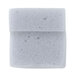 A small square of foam with holes on a white surface.