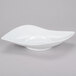 A CAC bright white porcelain eye bowl on a gray background.