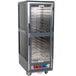 A large grey Metro C5 heated holding and proofing cabinet with shelves.