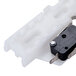 A white plastic Waring actuator switch with a black button.