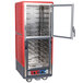 A red and silver metal Metro C5 holding and proofing cabinet with clear Dutch doors open.