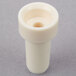 A white plastic Waring spacer tube with a hole.