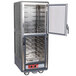 A gray Metro C5 hot holding cabinet with clear Dutch doors open.