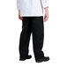 A person wearing Chef Revival baggy black chef pants.