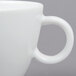 A close-up of a white Arcoroc Vintage coffee cup with a white handle.