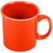 A close-up of a Fiesta Poppy orange coffee mug with a handle.