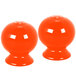 Two orange round Fiesta salt and pepper shakers.