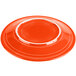 A red Fiesta dinner plate with a white rim.