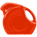 A red pitcher with a handle.