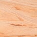 A close up of the wood surface of an American Metalcraft olive wood serving board.