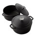 Two American Metalcraft black cast iron Dutch ovens with lids.