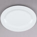 A Tuxton Alaska bright white china serving platter with a wide rim.