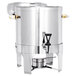 A Vollrath stainless steel coffee urn with brass trim and a black handle.