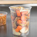 A Solo MicroGourmet plastic deli container filled with vegetables including carrots.