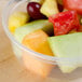 A Solo MicroGourmet deli container filled with a fruit salad on a table.