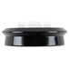 A black circular object with a clear plastic lid.