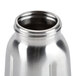 A Waring stainless steel blender jar with a lid.