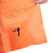 An orange mesh Cordova surveyor's vest pocket with pen and phone pockets.