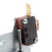 A close-up of a black and red micro switch for a Waring countertop range.