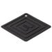 A black square shaped Lodge silicone pot holder on a table in a home kitchen.