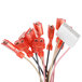 A group of red and white wires with a red connector.