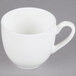 A close-up of a white CAC Majesty European bone china coffee cup with a handle.