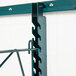 A Metroseal 3 metal shelf with green hooks attached to it.