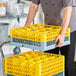 A Noble Warewashing 16-compartment gray full-size glass rack with two yellow extenders.
